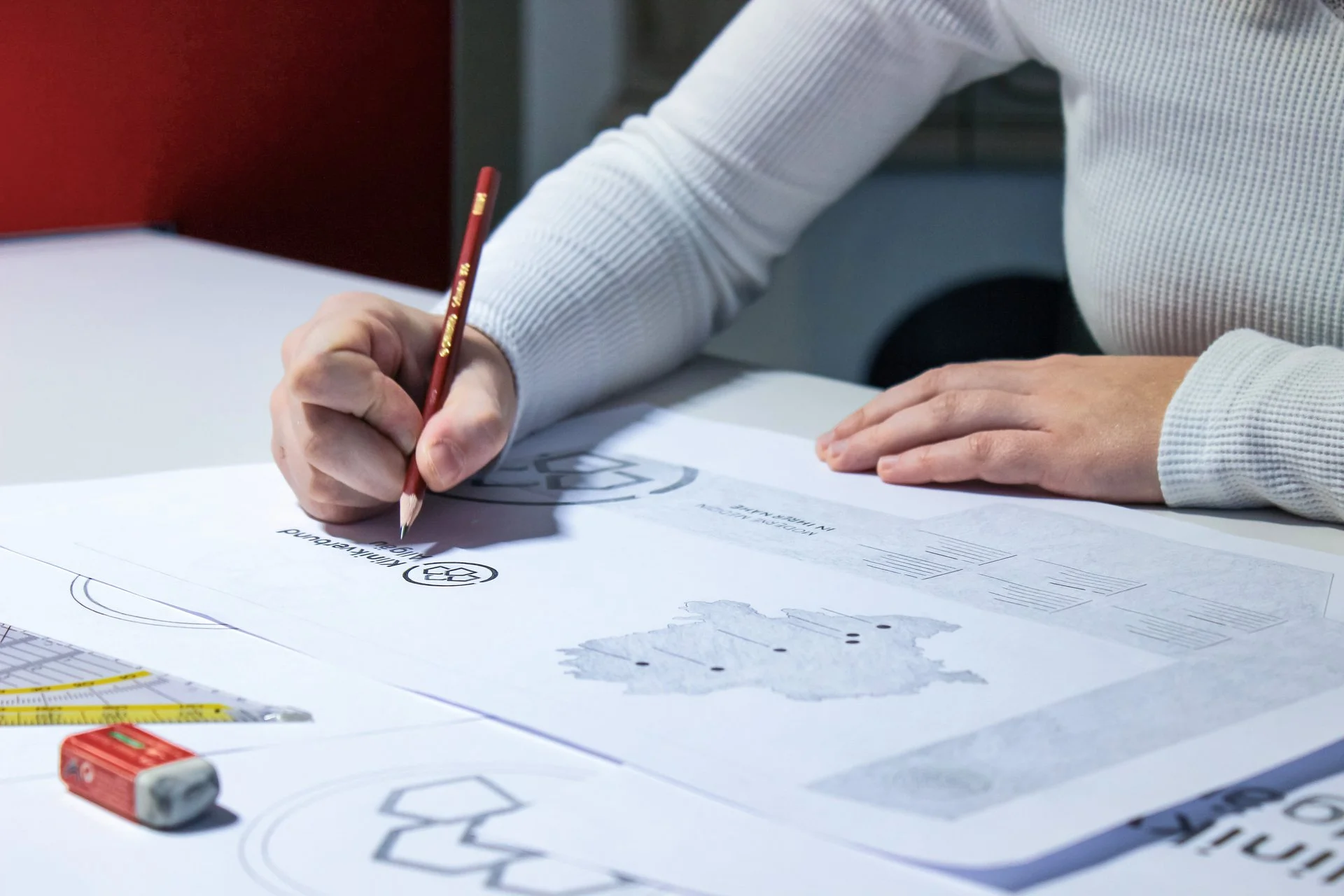 Hand zeichnet Logoentwurf auf Papier – kreative Markenentwicklung bei der Denkströme 
